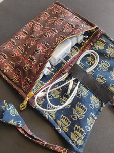 Sooti charger wrap can accommodate three mobile chargers. One can wrap earphones too in the band which is elasticated.  Sooti handmade charger wrap is a perfect travel accessory to keep belongings of your gadgets in one place, when open.