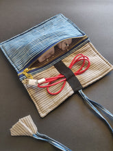 Load image into Gallery viewer, Sooti charger wrap stripes blue can accommodate three mobile chargers. One can wrap earphones too in the band which is elasticated.  Sooti handmade charger wrap is a perfect travel accessory to keep belongings of your gadgets in one place.